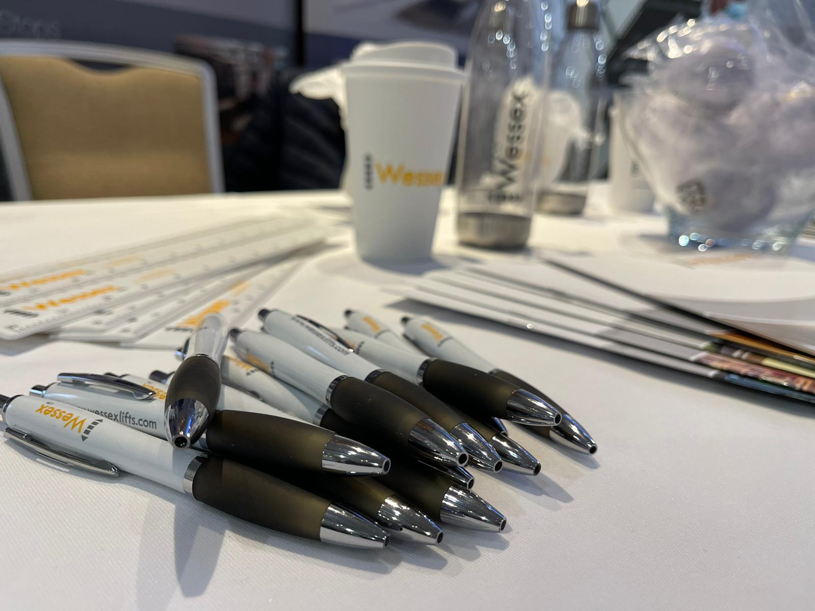 Wessex branded pens, rulers, stress balls, and brouchers on the table for people to pick up, at the OTAC show, Leeds, 2021.