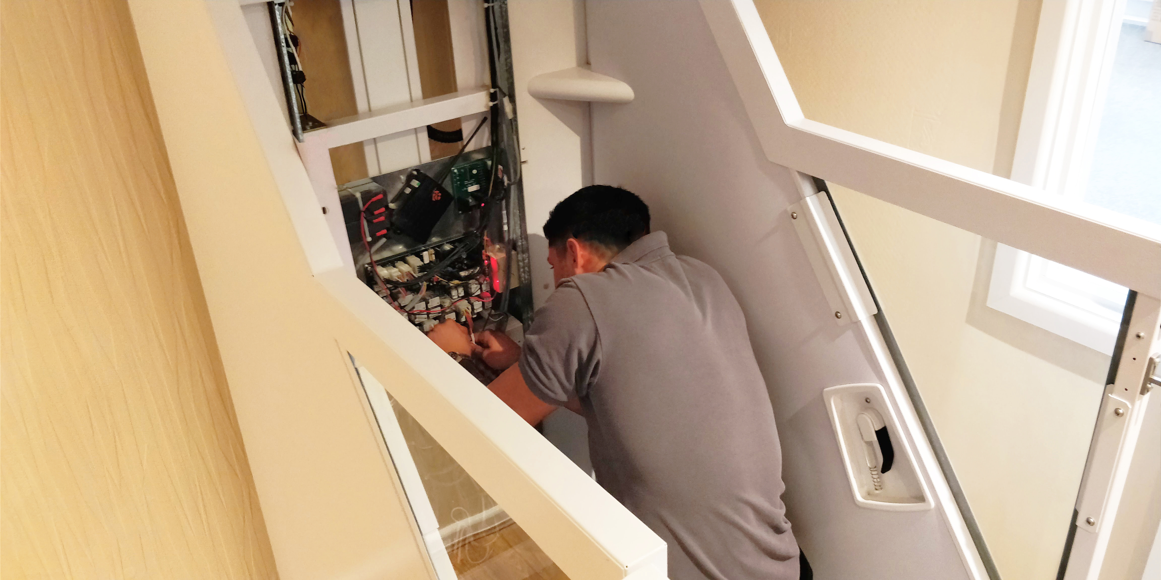 A member of our maintenance team, working on a home lift.